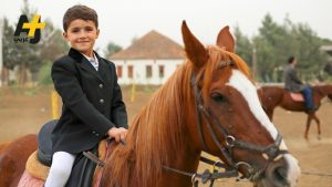 A Lebanese child who is skilled in the sport of horseback riding